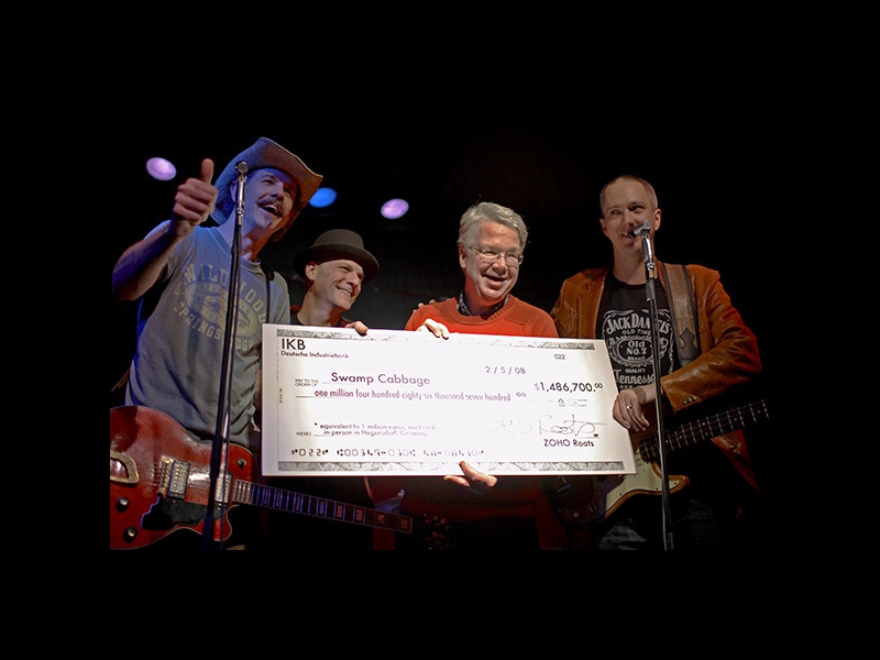 New York, February 5, 2008: After a prolonged battle with several major labels, Jochen Becker finally remained victorious in signing Northern Florida Blues / Roots Rockers SWAMP CABBAGE to his ZOHO ROOTS label. At the CD Release Party in New York�s Cutting Room, Jochen presented the trio with their sign-up bonus check.