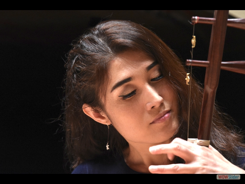 The beautiful and soulful erhu player Feifei Yang, at dress rehearsal. The erhu is a traditional Chinese bowed string instrument with two strings. Photo: Melanie Futorian.